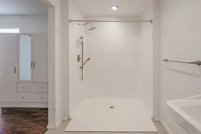 a bathroom with a shower and bathtub