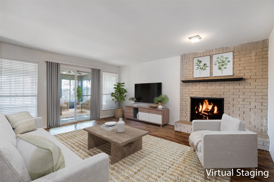 2106 Lamplight Village Circle, Unit A Austin, TX 78727 - Photo 2 of 19 a living room with furniture a flat screen tv and a fireplace