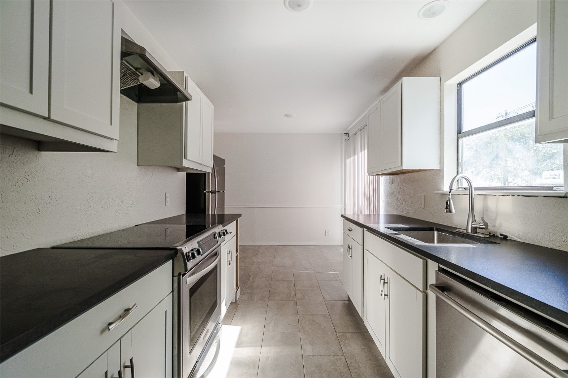 2106 Lamplight Village Circle, Unit A Austin, TX 78727 - Photo 3 of 19 a kitchen with granite countertop a sink and stainless steel appliances