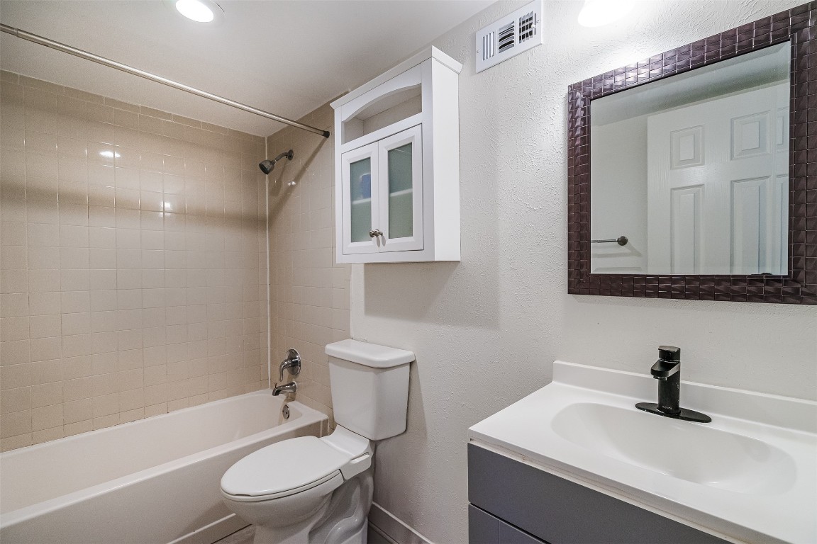 2106 Lamplight Village Circle, Unit A Austin, TX 78727 - Photo 9 of 19 a white toilet sitting next to a bathroom sink