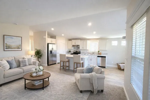 a living room with furniture and kitchen view