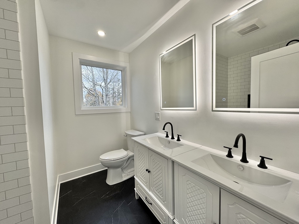20 Broad Street, Unit 4 Medway, MA 02053 - Photo 6 of 10 a bathroom with a toilet sink and mirror