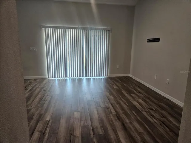 a view of a room with wooden floor