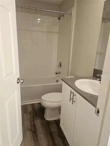 a white toilet sitting next to a bathroom sink