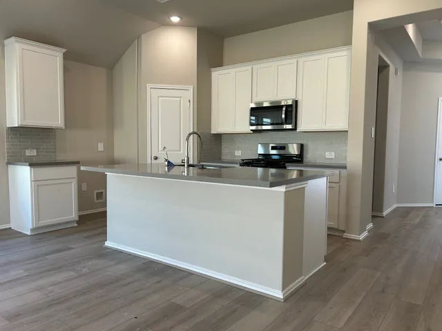 a view of a bathroom with a bathtub and door