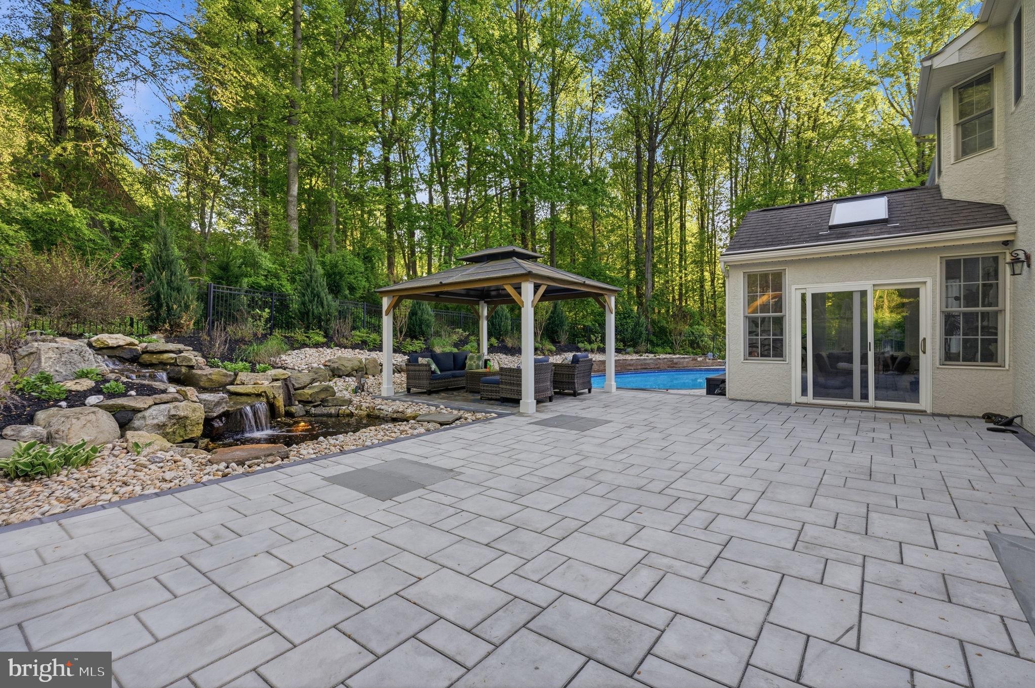 1350 Skelp Level Road Downingtown, PA 19335 - Photo 38 of 50 a view of a patio with table and chairs under an umbrella