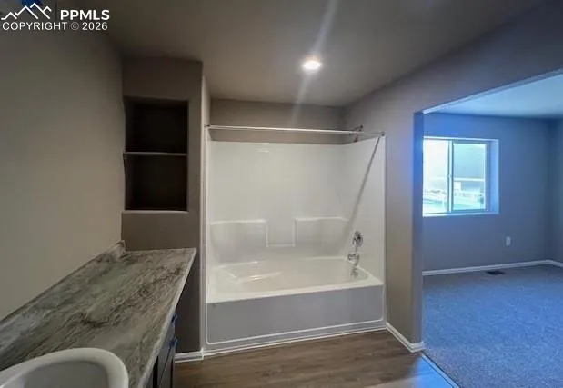 a bathroom with a tub and shower
