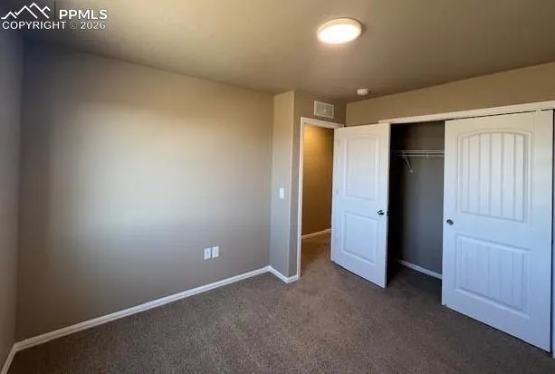 an empty room with closet area