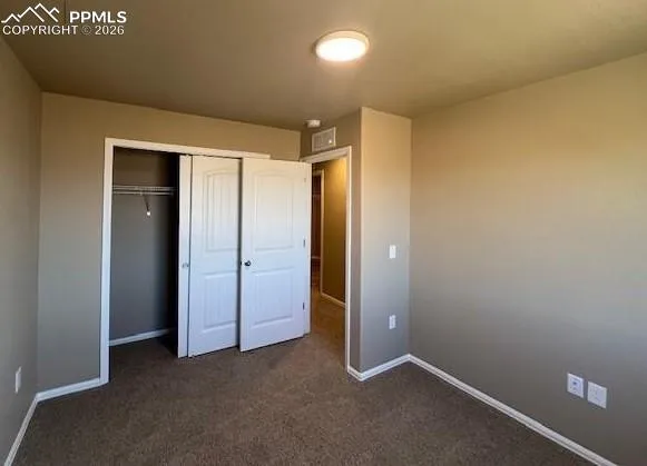 an empty room with closet area
