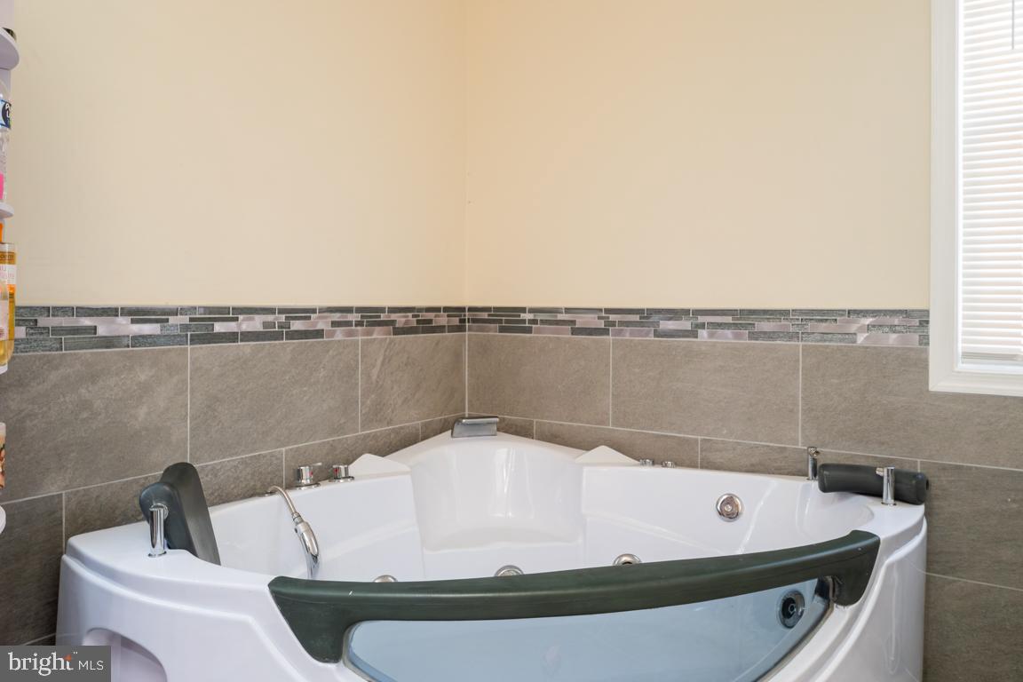 1710 Bargers Road Gambrills, MD 21054 - Photo 21 of 22 a bath tub sitting next to a blue sink