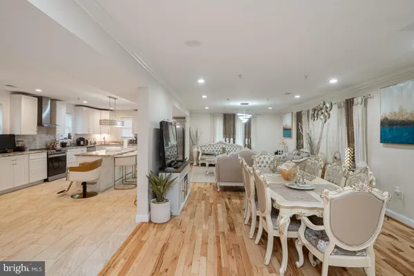 a large kitchen with a table and chairs
