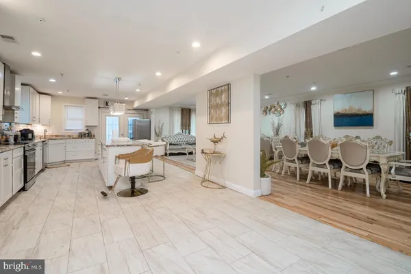 a living room with lots of furniture and kitchen view