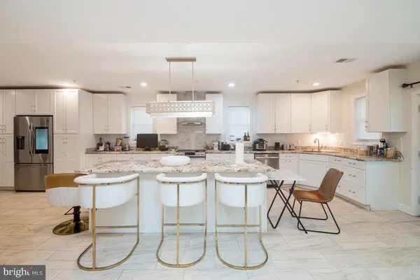 a kitchen with a sink and white cabinets