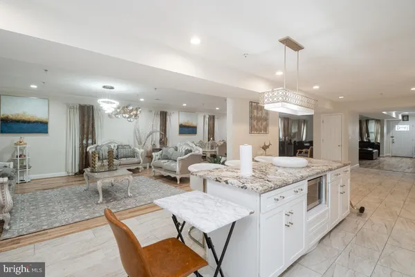 a large kitchen with a counter top space appliances and cabinets