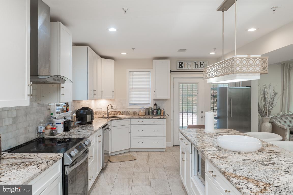 1710 Bargers Road Gambrills, MD 21054 - Photo 10 of 22 a kitchen with stainless steel appliances granite countertop a sink stove and refrigerator