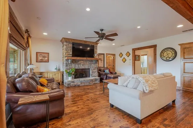 a living room with fireplace furniture and a flat screen tv