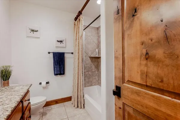 a bathroom with a granite countertop shower sink and vanity