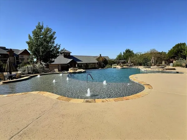 a view of a swimming pool with an outdoor seating