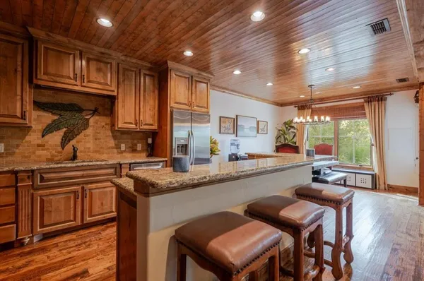 a kitchen with granite countertop lots of counter top space and wooden floor
