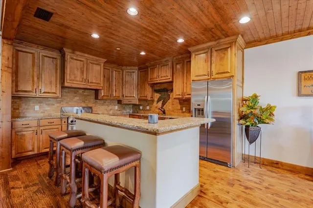 a kitchen with kitchen island granite countertop wooden cabinets and counter space