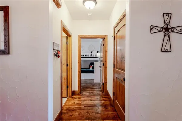a hallway with white walls and stairs