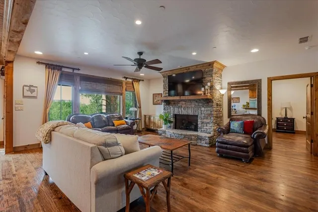 a living room with furniture a fireplace and a flat screen tv