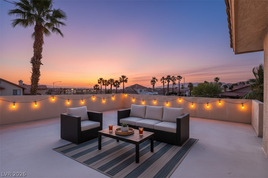 3698 Laughlin Boulevard Laughlin, NV 89029 - Photo 3 of 49 Twilight hues adorn a private rooftop patio, ideal for relaxing evenings under string lights and palm trees.
