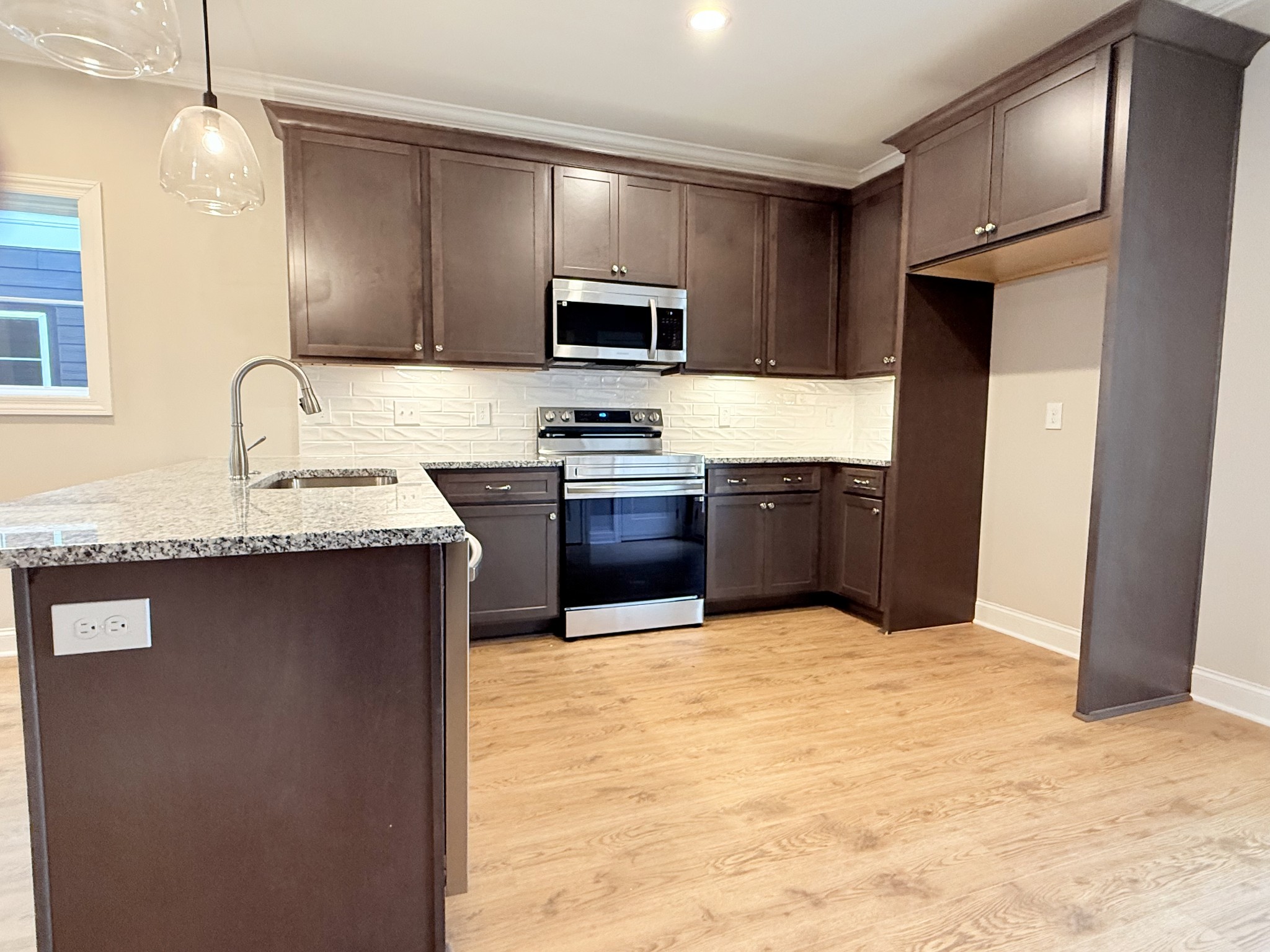 1367 Rebecca Johns Drive Murfreesboro, TN 37128 - Photo 11 of 32 a kitchen with stainless steel appliances granite countertop a sink stove and refrigerator