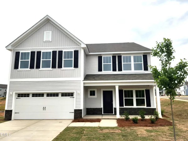 a front view of a house with yard