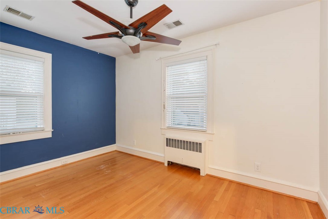 144 Meredith Street Hampton, VA 23669 - Photo 31 of 36 an empty room with a window and a ceiling fan