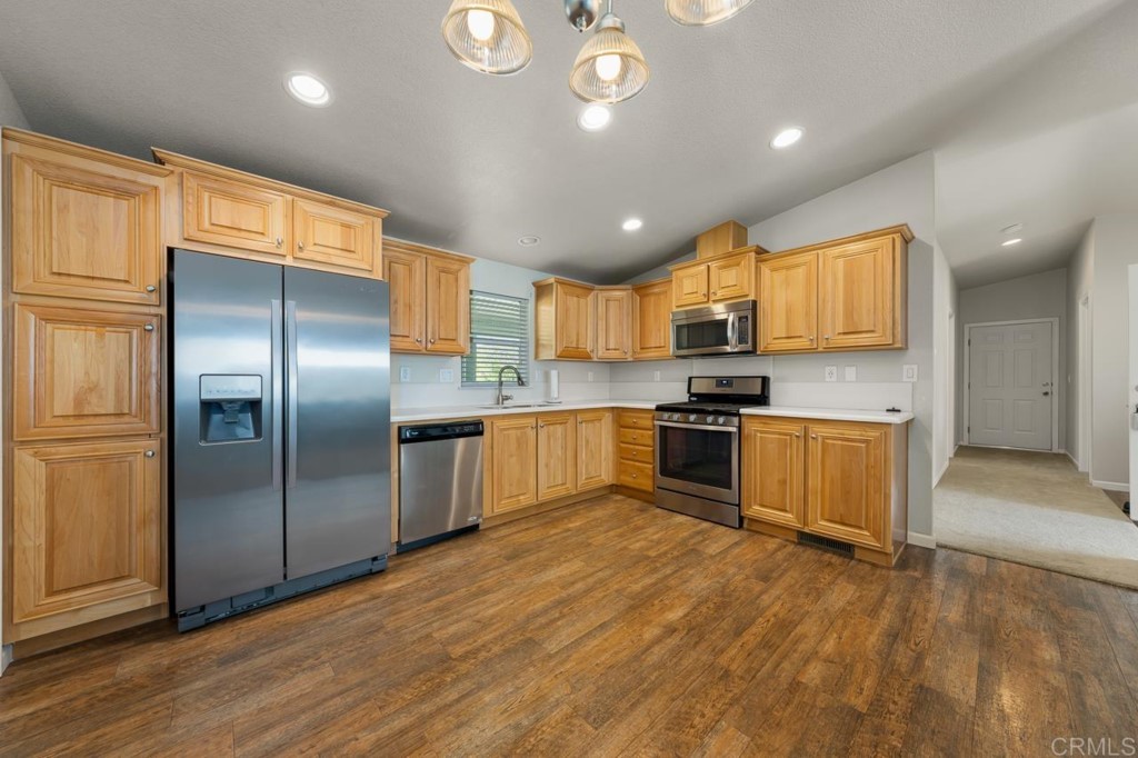 2400 Alpine Boulevard, Unit SPC 155 Alpine, CA 91901 - Photo 5 of 15 a kitchen with granite countertop a refrigerator and a stove top oven