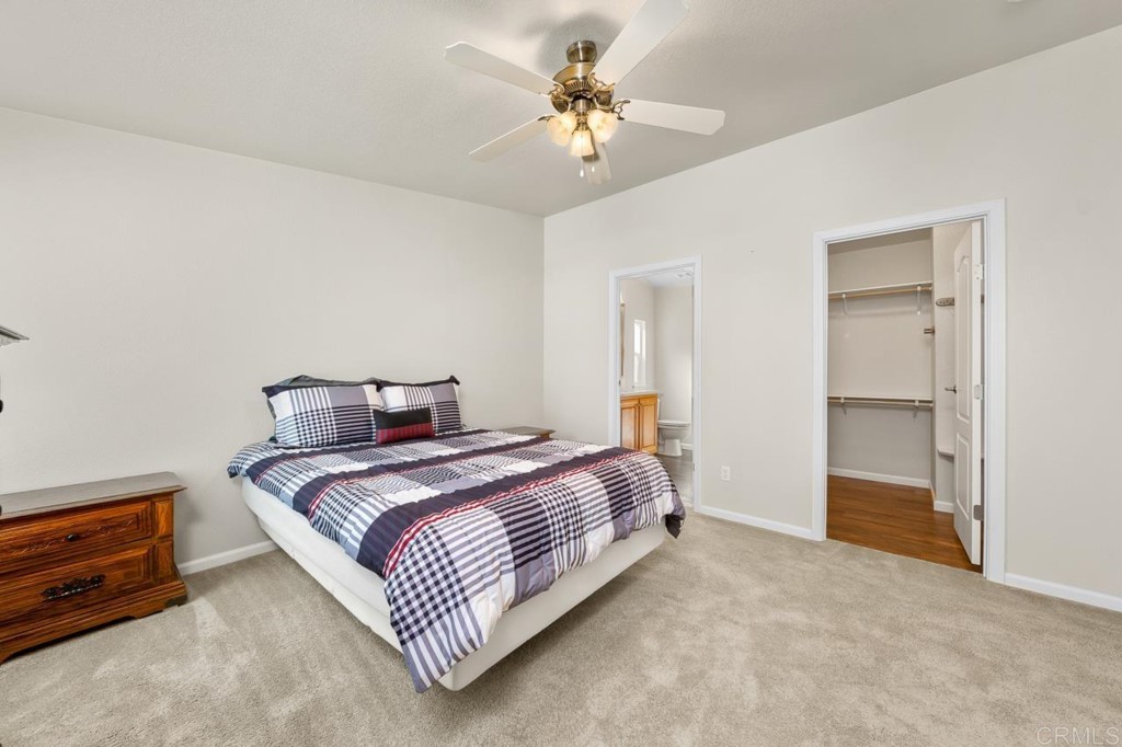 2400 Alpine Boulevard, Unit SPC 155 Alpine, CA 91901 - Photo 8 of 15 a spacious bedroom with a bed and a chandelier