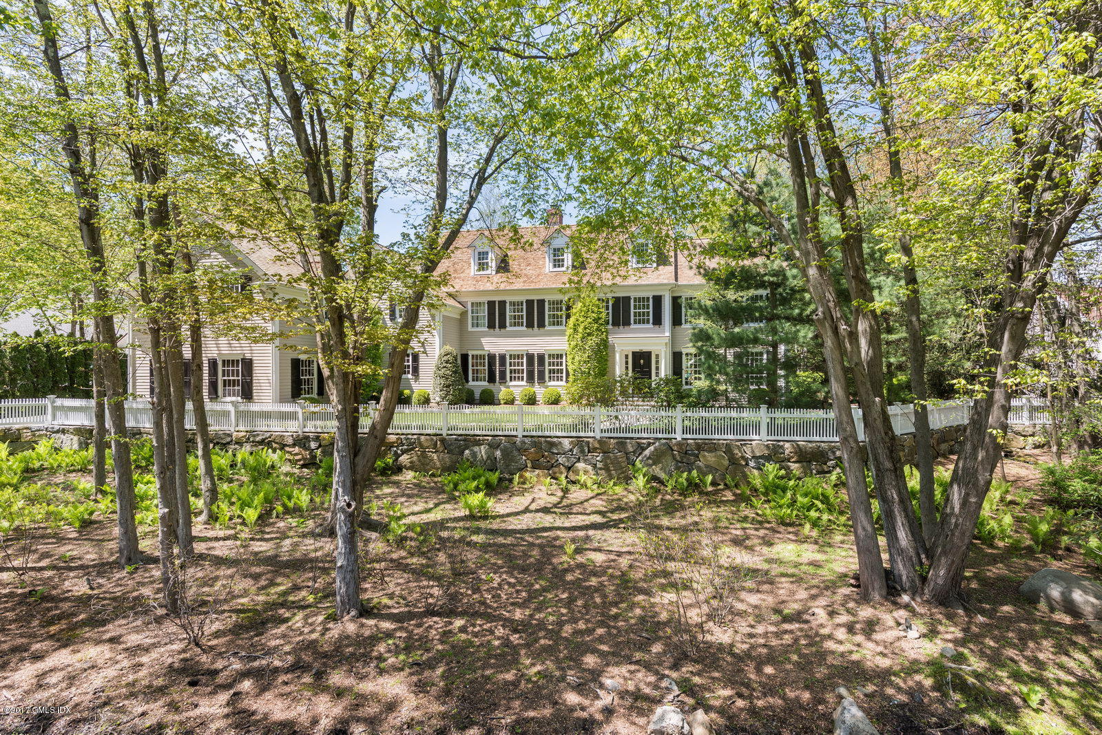 9 Roberta Lane Greenwich, CT 06830 - Photo 2 of 25 a front view of a house with a garden