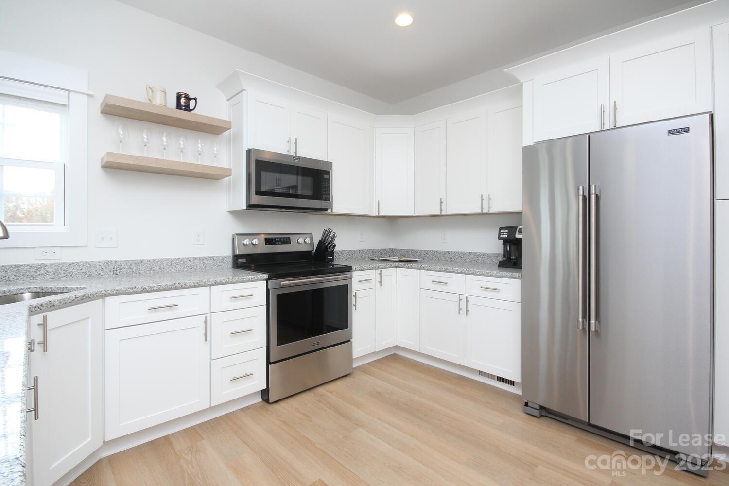 1082 Startown Road Lincolnton, NC 28092 - Photo 15 of 48 a kitchen with granite countertop white cabinets and stainless steel appliances