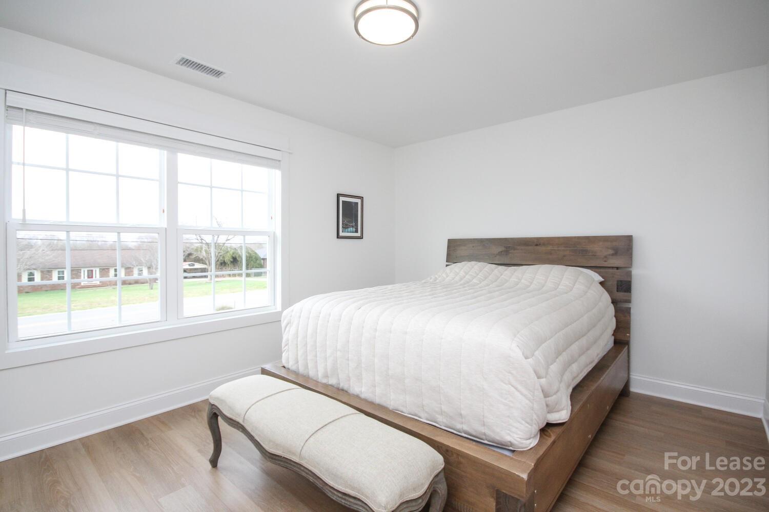 1082 Startown Road Lincolnton, NC 28092 - Photo 40 of 48 a large white bed sitting in a room next to a window