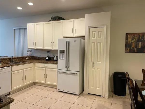 a kitchen with stainless steel appliances granite countertop a refrigerator sink and cabinets