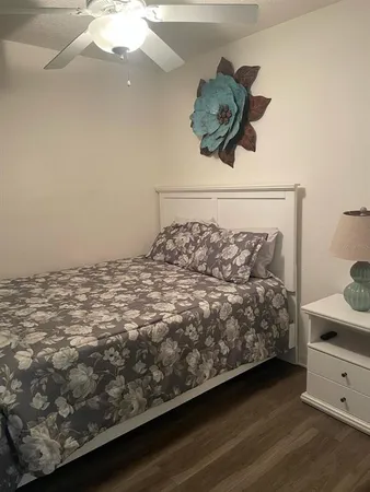 a bedroom with a bed and a dresser