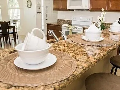 a view of a dining room with a table and chairs