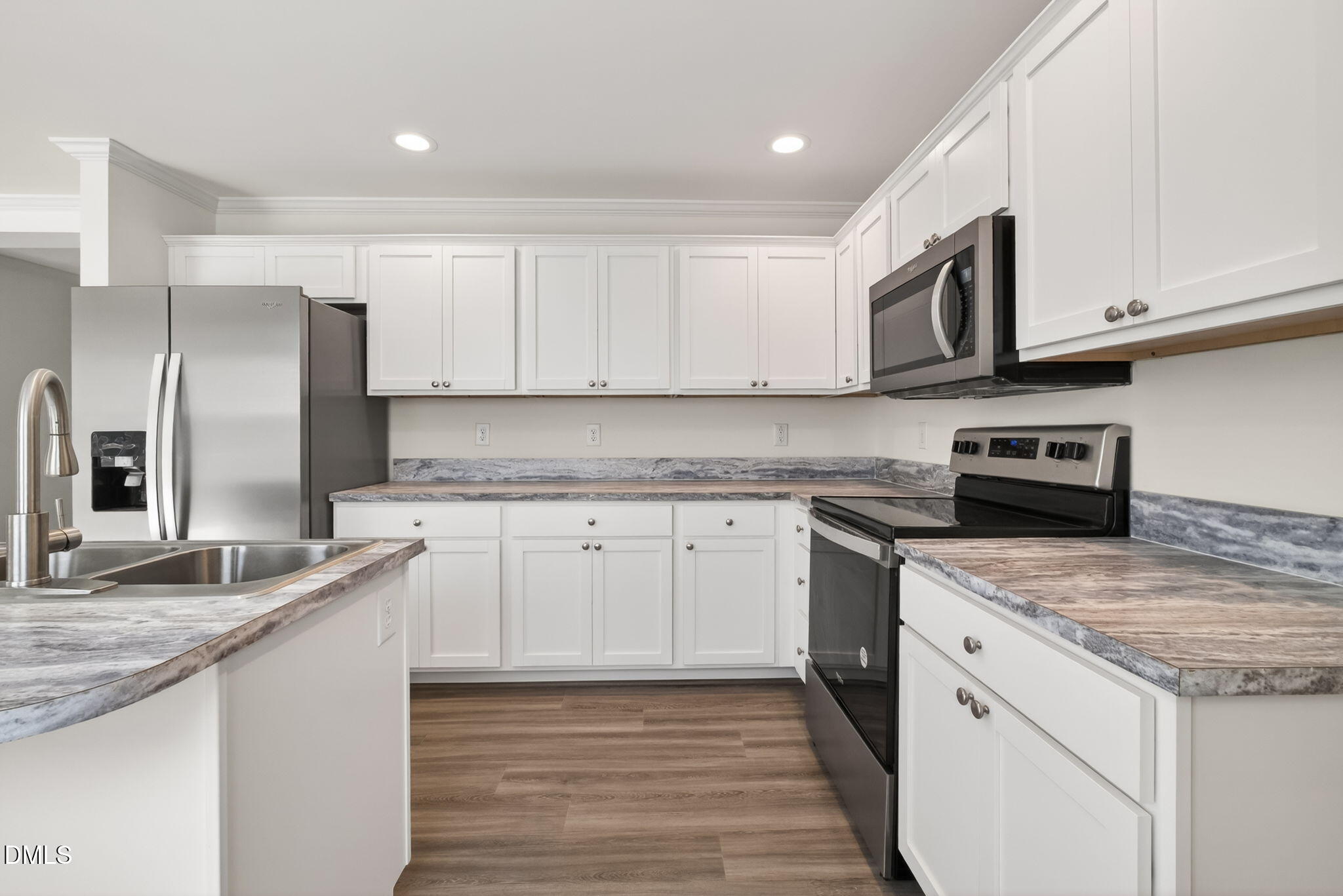 7122 Guess Road Hillsborough, NC 27278 - Photo 7 of 48 a kitchen with granite countertop white cabinets and stainless steel appliances