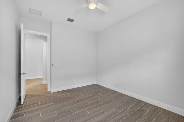 a large kitchen with stainless steel appliances kitchen island a large counter top and a refrigerator