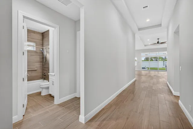 a view of a hallway with wooden floor