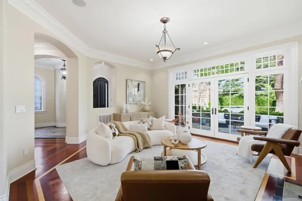 a kitchen with a dining table chairs sink and wooden floor
