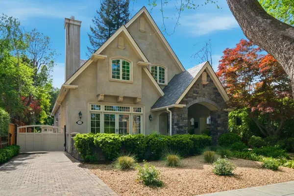 a front view of a house with a garden