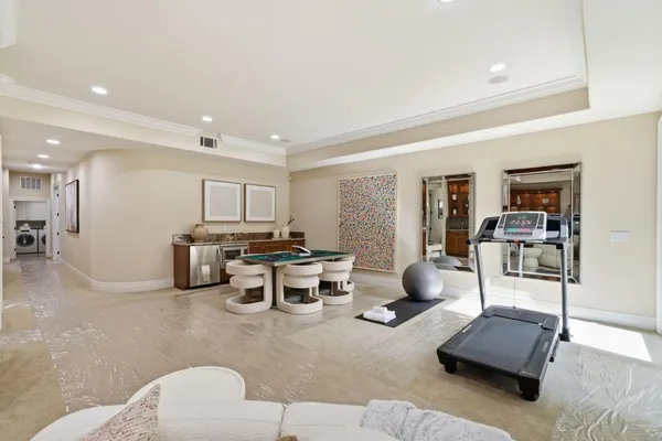a spacious bedroom with a bed and a flat screen tv