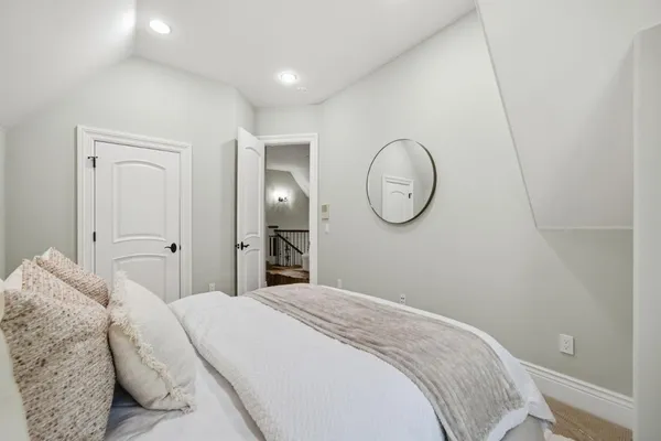 a view of a house with a small yard next to a road