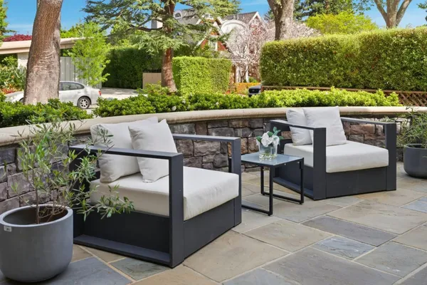a living room with furniture a fireplace and a large window