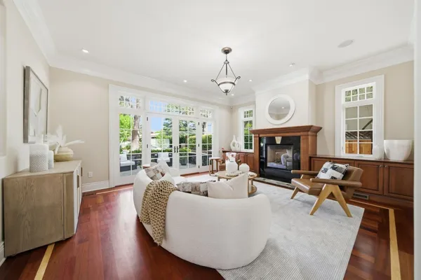 a living room with fireplace furniture and a large window