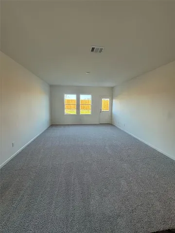 a view of an empty room with windows