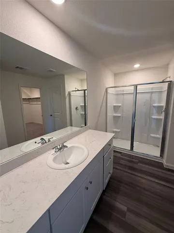 a bathroom with a double vanity sink and a mirror