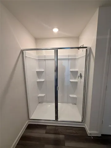 a bathroom with a glass door shower
